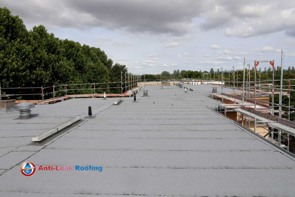 The roof of a building is being re-roofed.